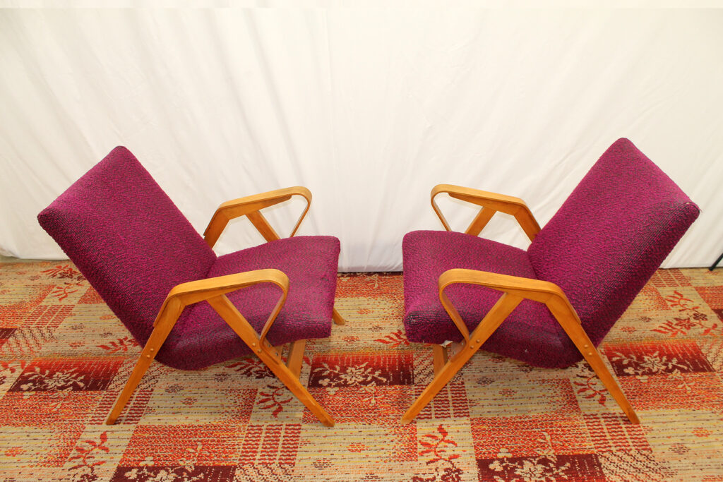 a couple of chairs sitting on top of a rug.
