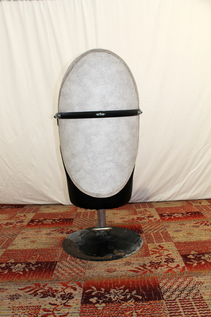 a large white object sitting on top of a metal stand.